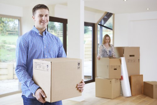 Removal van parked for a home move with boxes being loaded