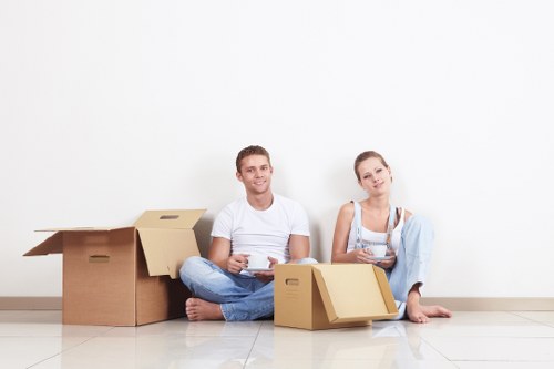 Professional movers carrying furniture from a Bayswater flat
