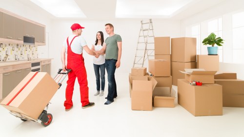 Team moving household items through a Bayswater property access area